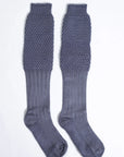 Gray Bavarian socks with ribbed lower and honeycomb knit upper, laid flat on white background.